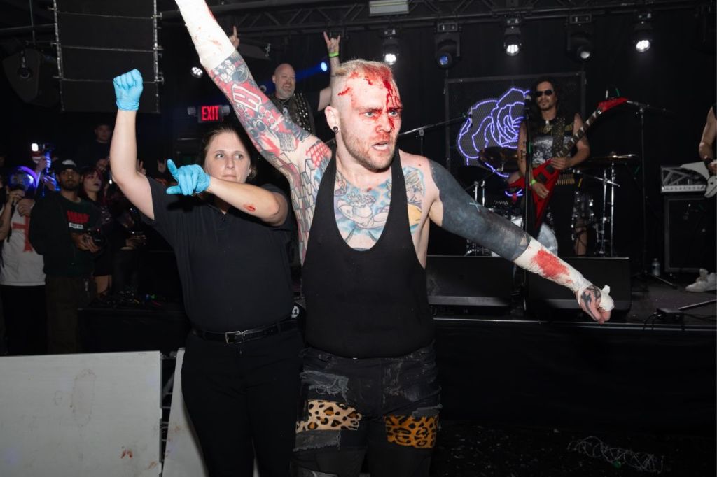 Photo of a man with blood on his head at a wrestling match 