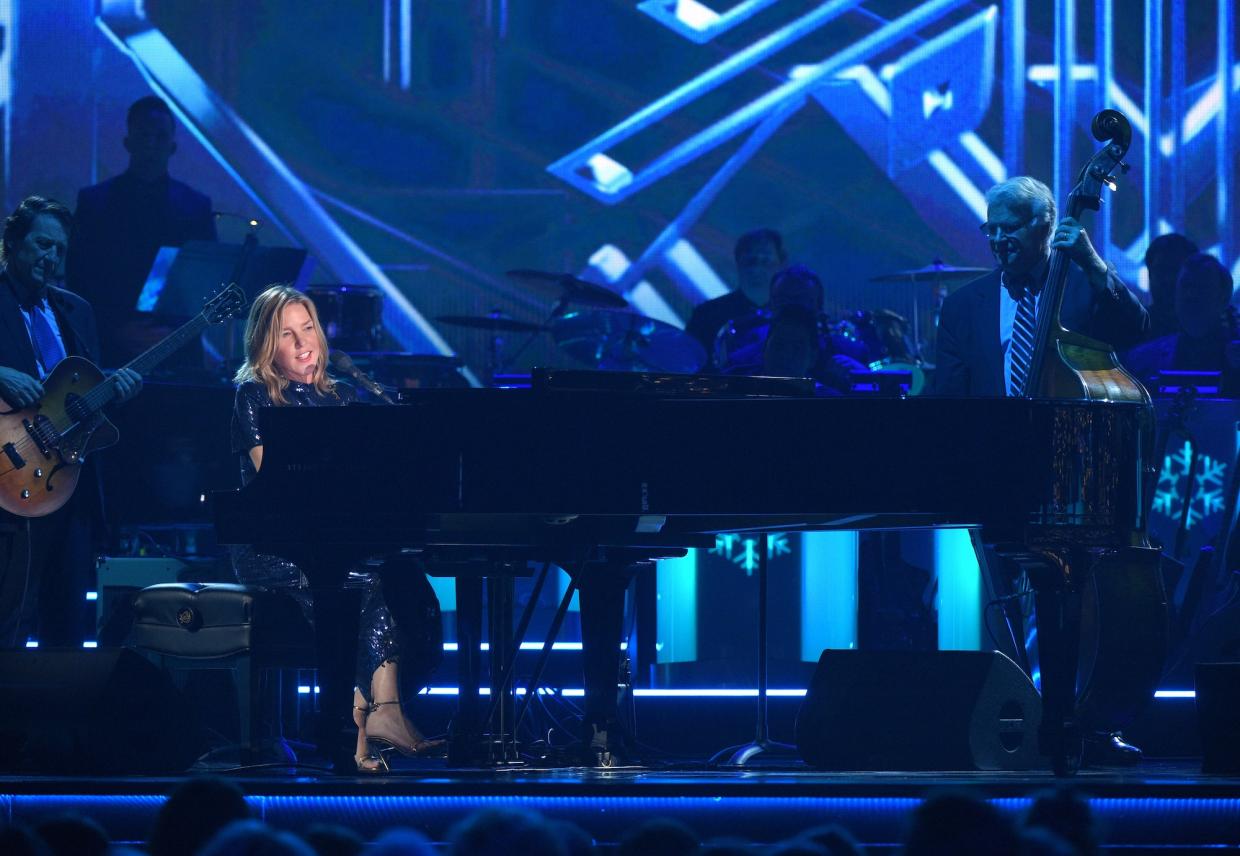 A woman playing piano on stage