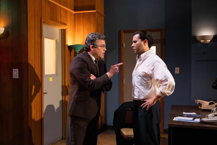 photo of two theater actors performing onstage
