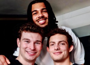 photo of three football players posing together
