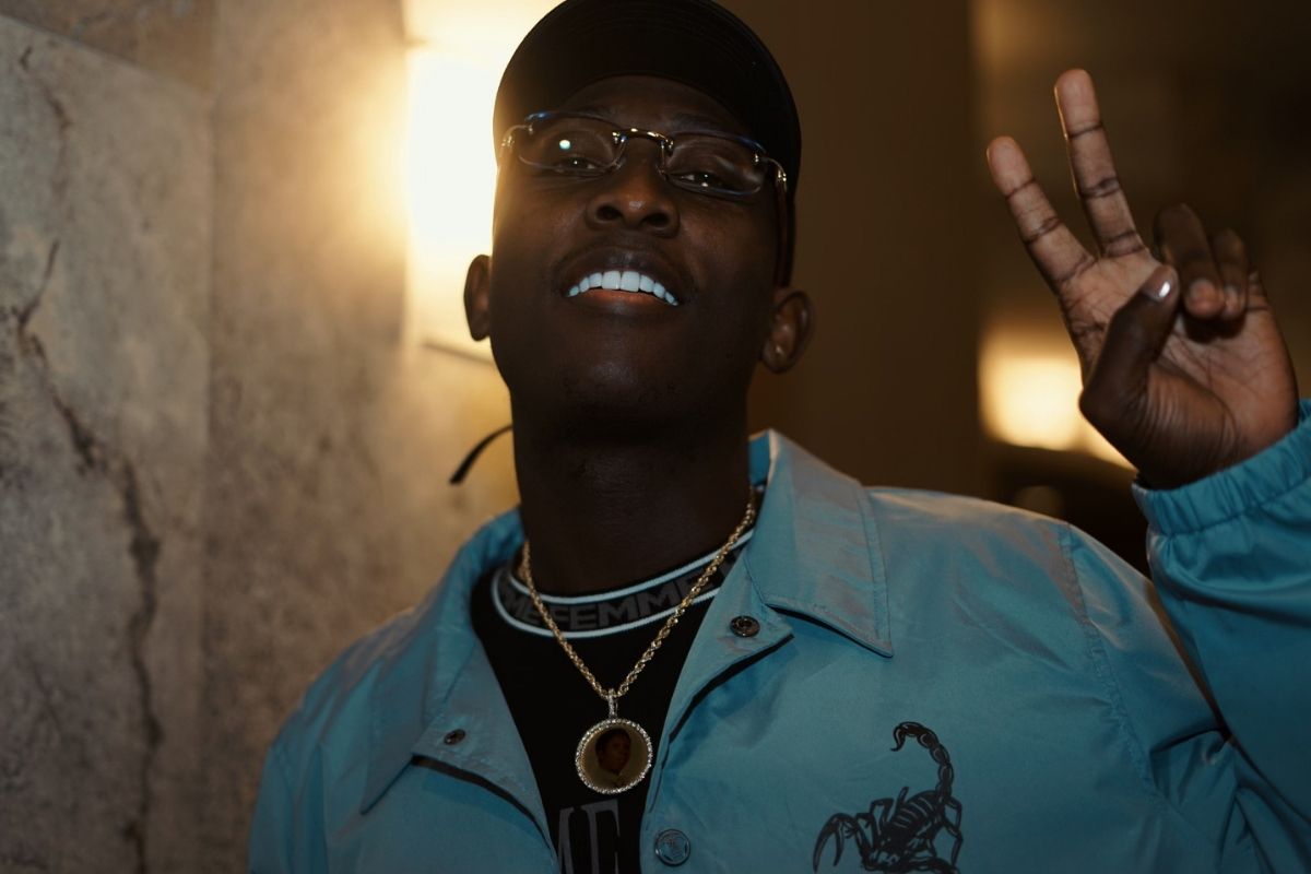 Portrait of a man doing the peace sign with his fingers.