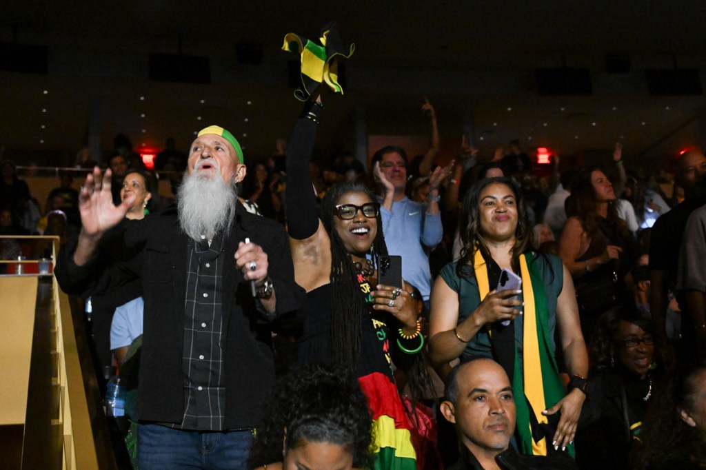A group of people standing at a concert singing