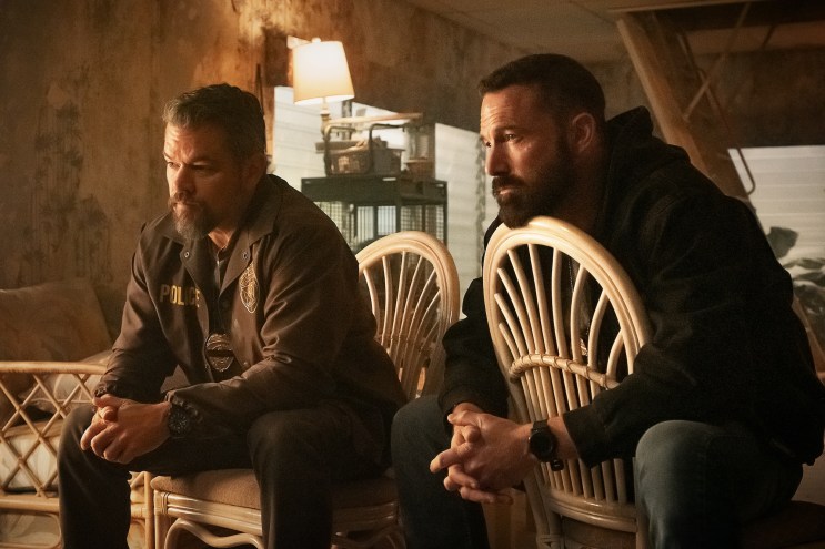 film still of Matt Damon and Ben Affleck dressed as detectives sitting on chairs