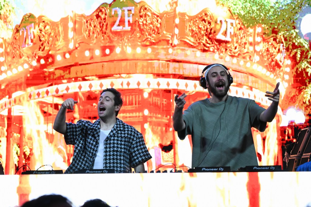 Two DJs performing at a carrousel