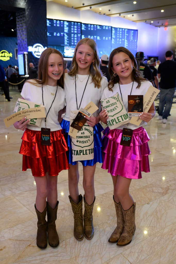 Three girls wearing Americana outfits at a concert