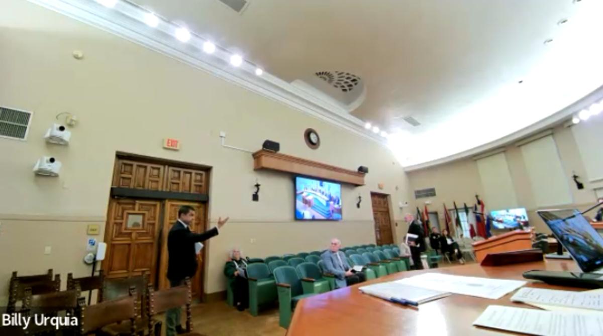 Vince Lago pointing towards the commission as he stands by the door to exit the commission chambers.