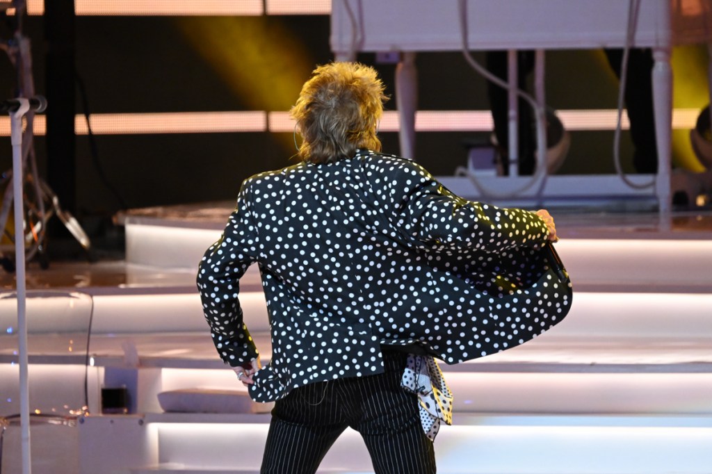 Photo of a man's back while he is dancing 