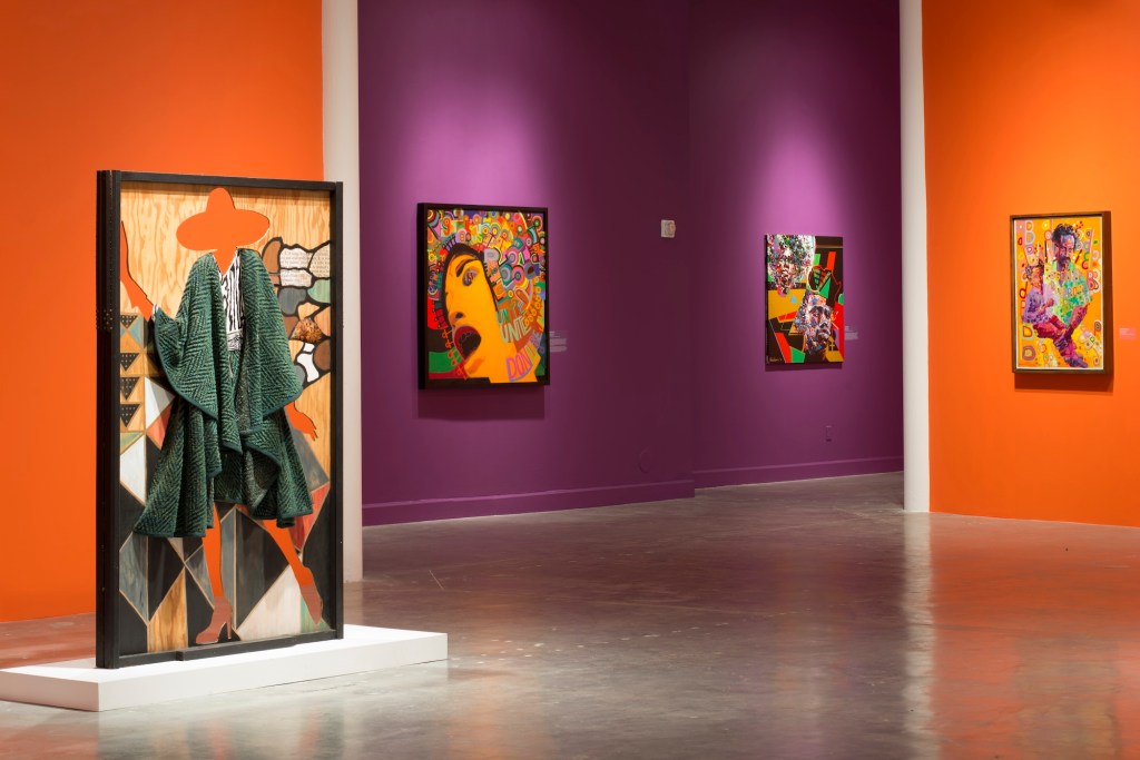 photo of paintings hanging on orange and purple museum walls