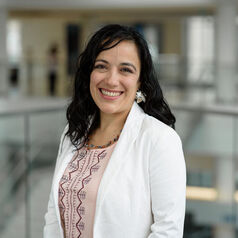headshot of researcher Angélica Durán-Martínez wearing a blouse and white blazer