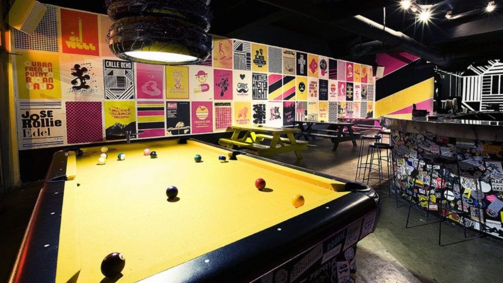 Photo of a place with a pool table and posters