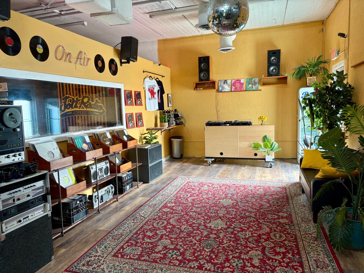 Photo of a space with vinyl records and DJ equipment