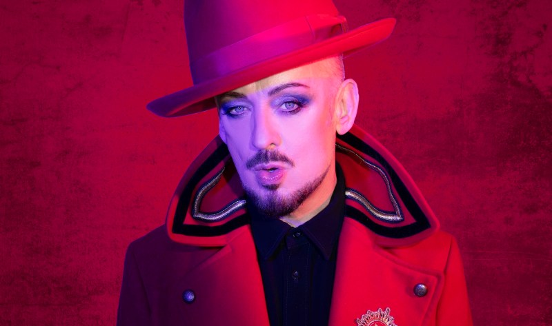 photo of singer Boy George in a red fedora hat and red coat