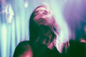 photo with a blurry, psychedelic effect of a long-haired man's face