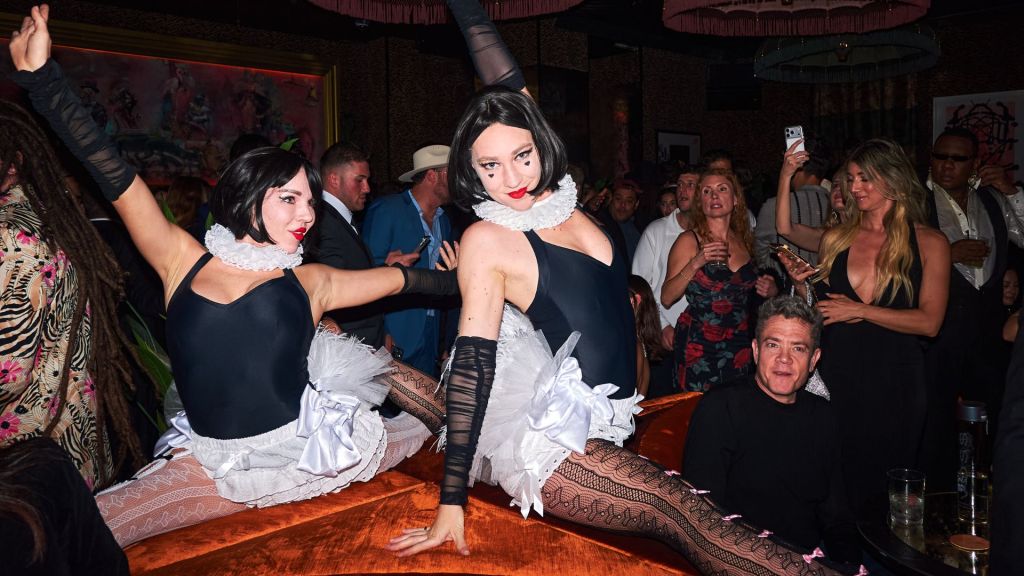 Photo of two dancers dressed in mime outfits at a club