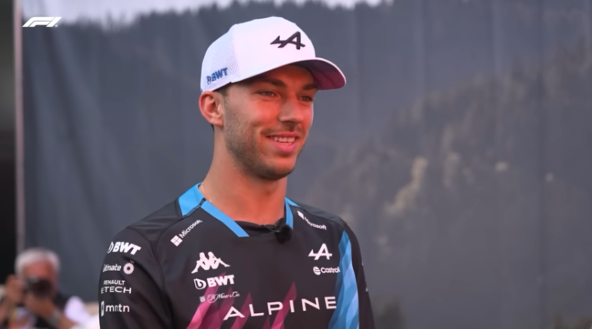 Pierre Gasly wears Alpine racing shirt and white baseball cap