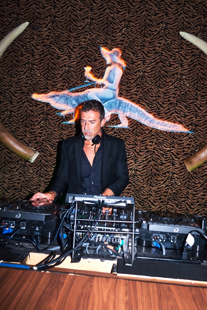 Photo of a DJ behinf the booth. 