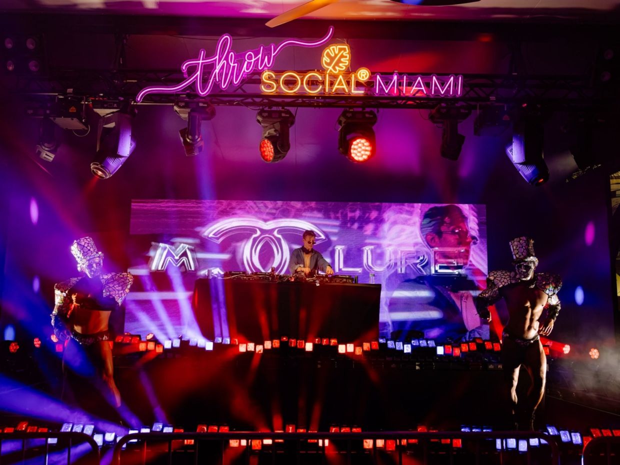 Photo of a stage at a venue in Miami that reads Throw Social