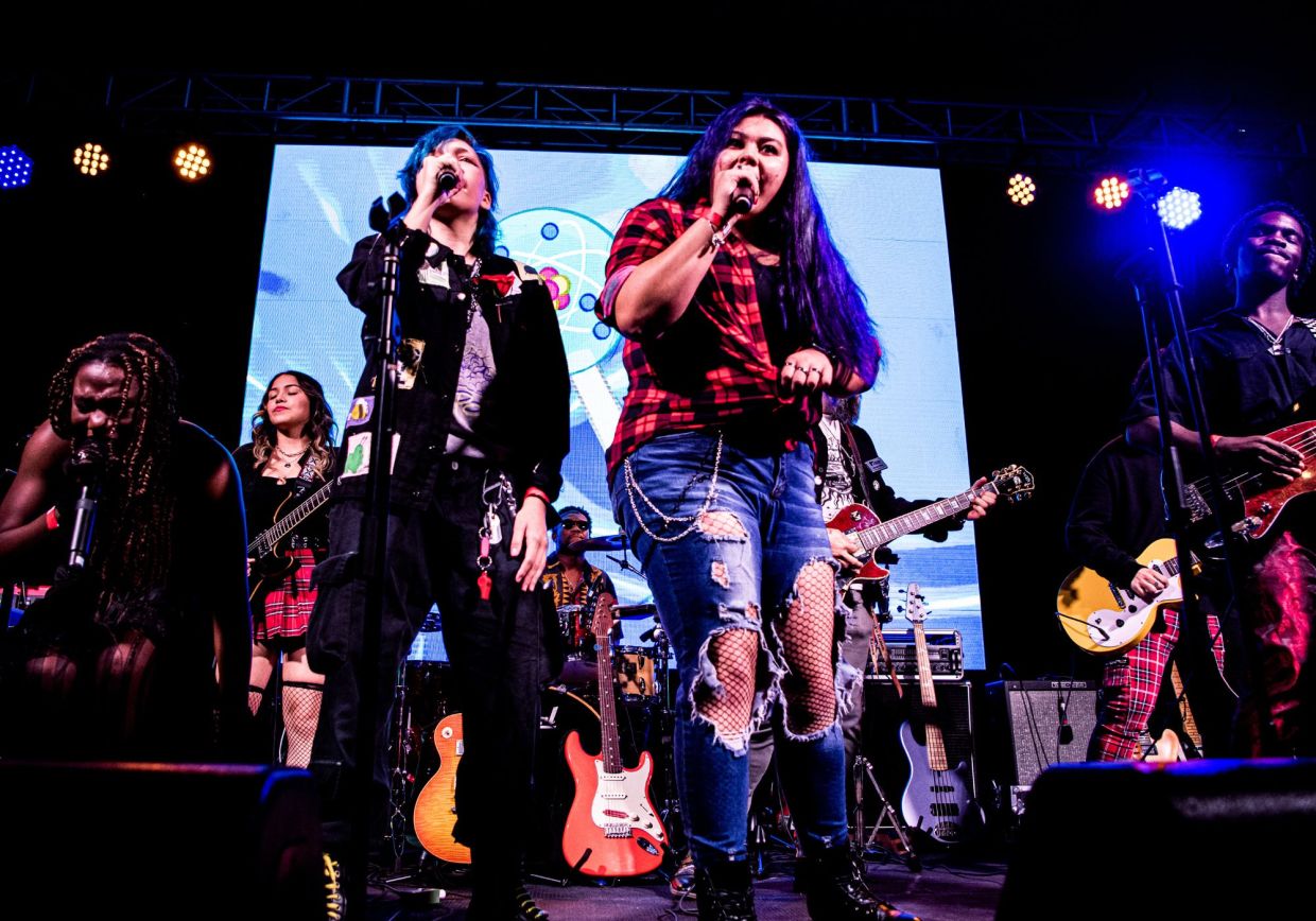 Photo of a group of young musicians on stage singing in Miami