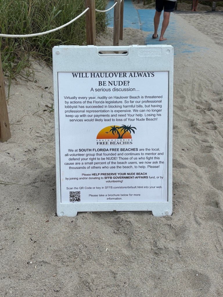 photo of a sign asking for donations for a group that lobbies for Haulover Beach to stay clothing-optional