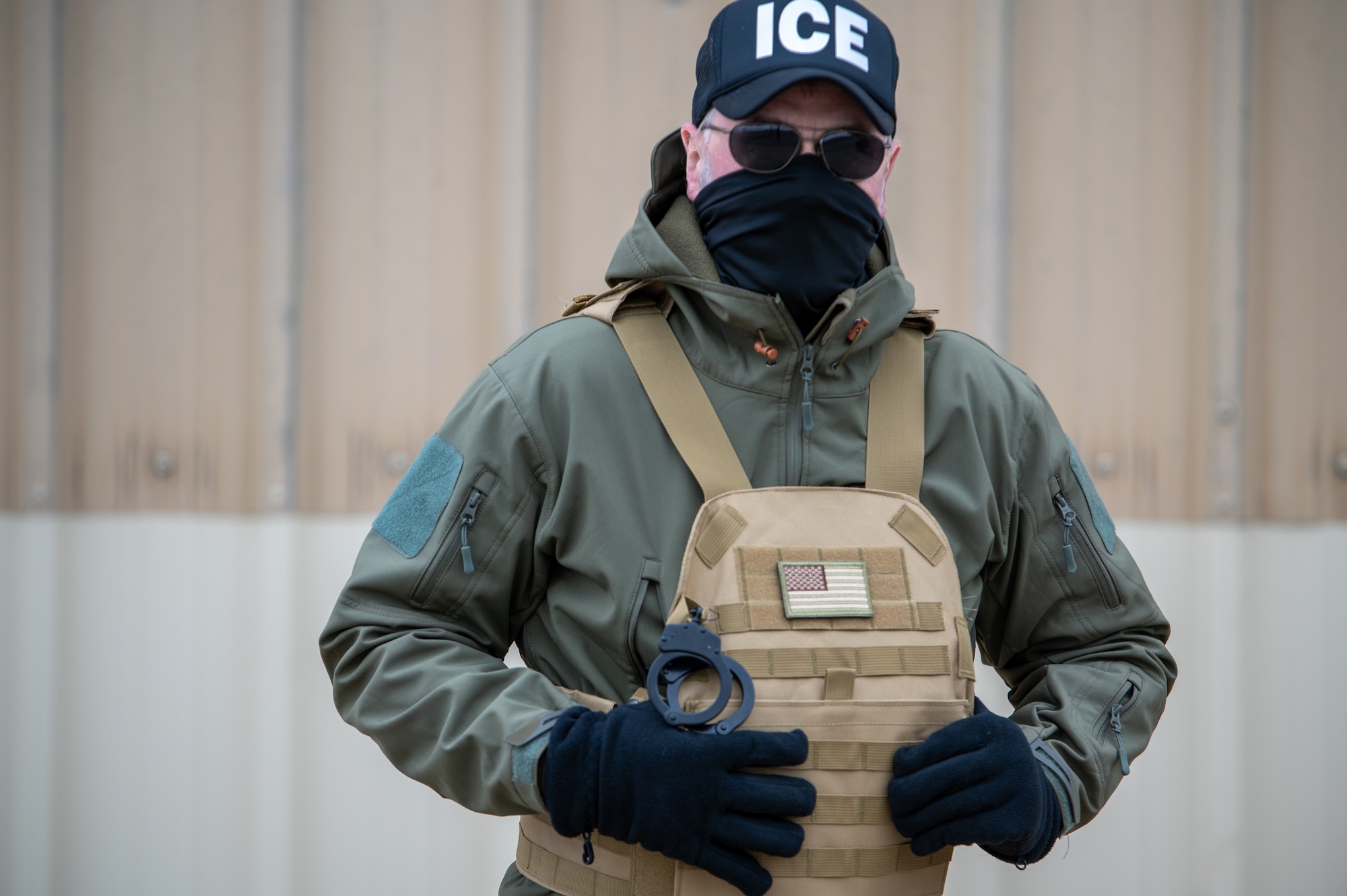 photo of an ICE agent in a mask and uniform
