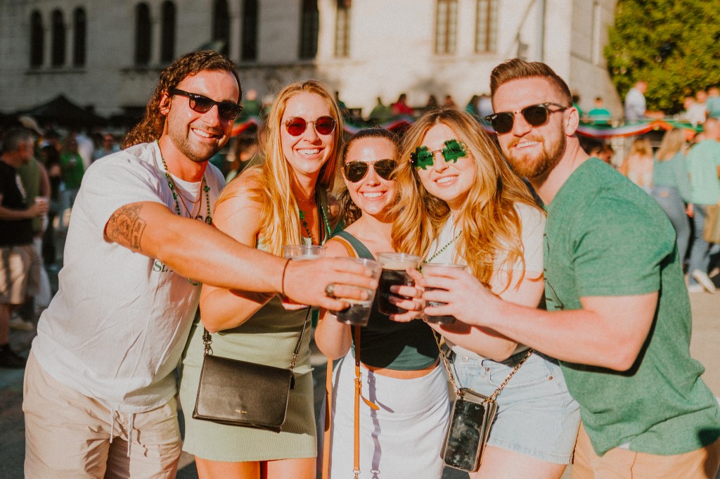 group of people dressed in green for St. Patrick's Day outside in the sun in Coral Gables