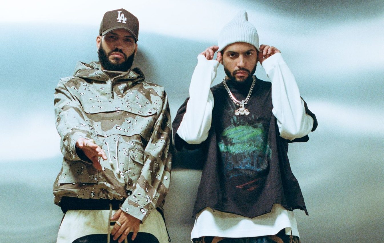 Photo of the Martinez Brothers standing by a white background