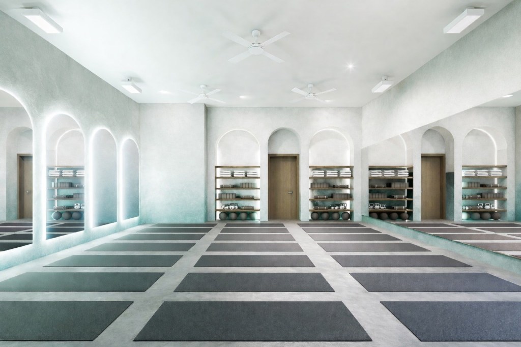 rendering of a yoga studio with rows of mats on the floor and domed mirrors on the left