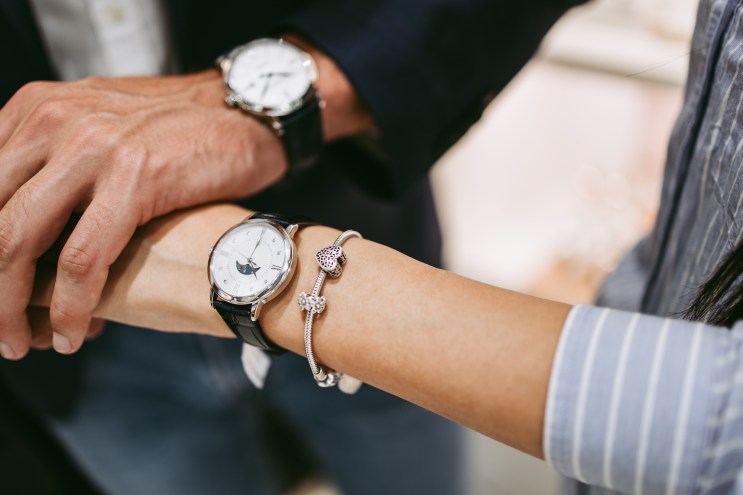 photo of a man and woman's wrists sporting watches