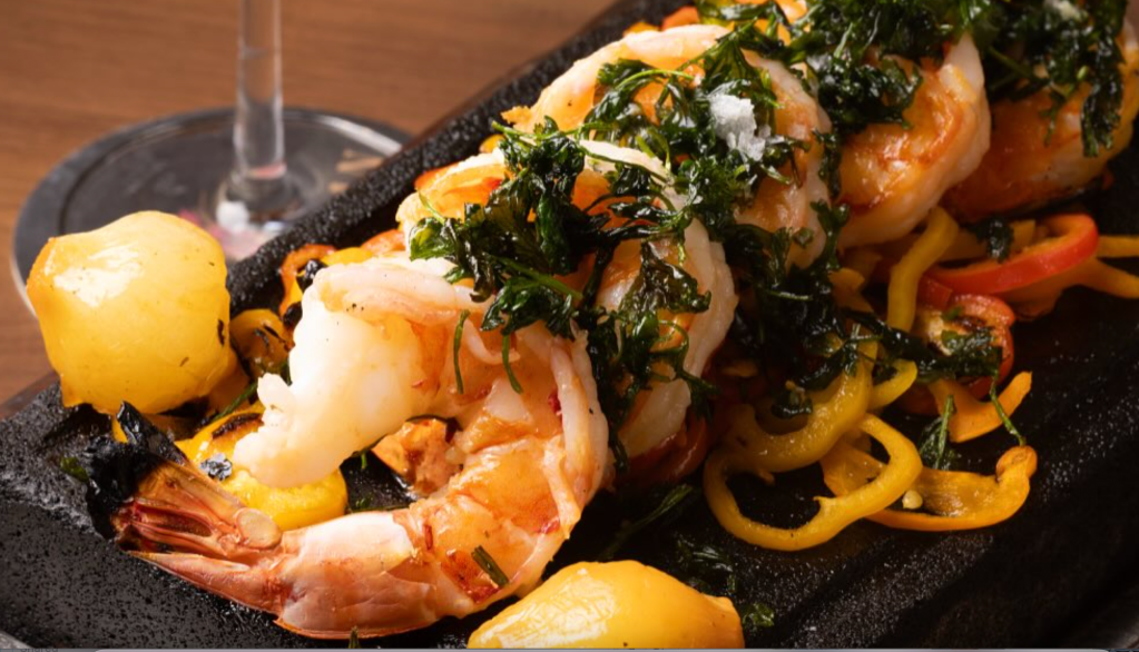 shrimp and seafood on a plate with sauces