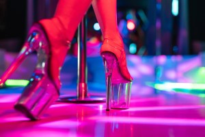 close-up photo of a stripper's feet in stripper heels on stage
