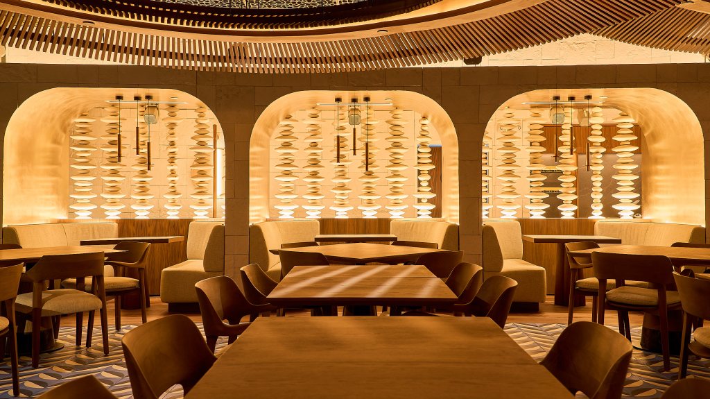 a modern white dining room with art and arches