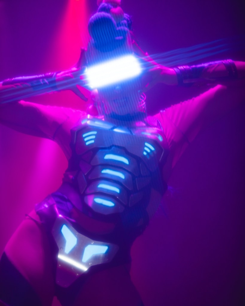 Photo of a woman wearing an LED Helmet and suit