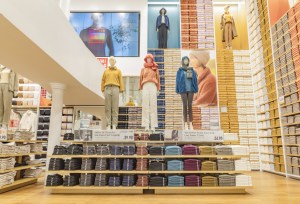 A photo of mannequins wearing winter clothing inside a Uniqlo clothing store.