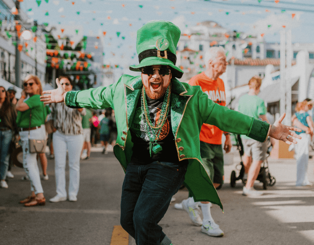 a man in all green wearing a leprechaun outfit at a St. Patrick's Day festival