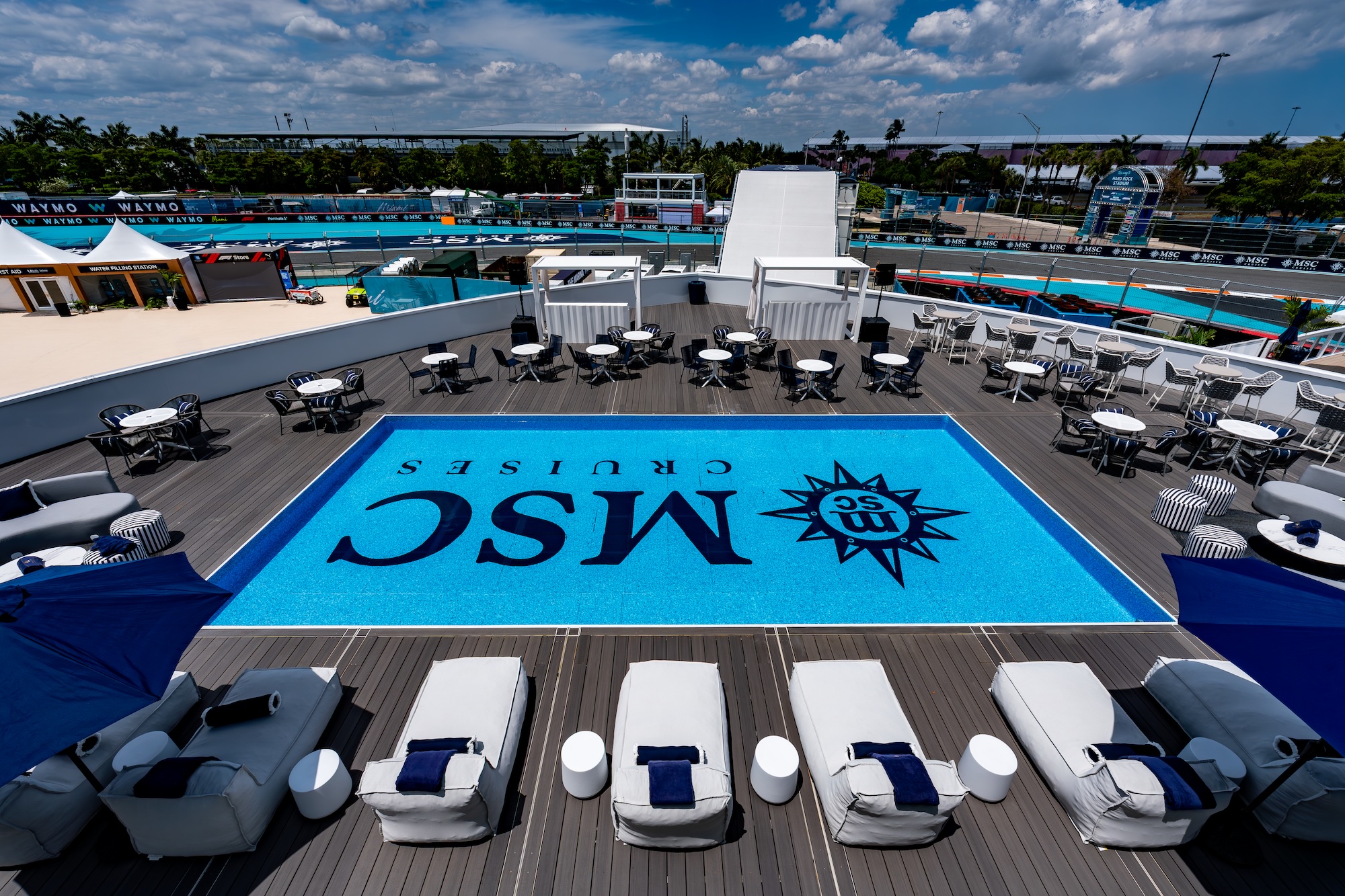 photo of a pool deck in front of a race track