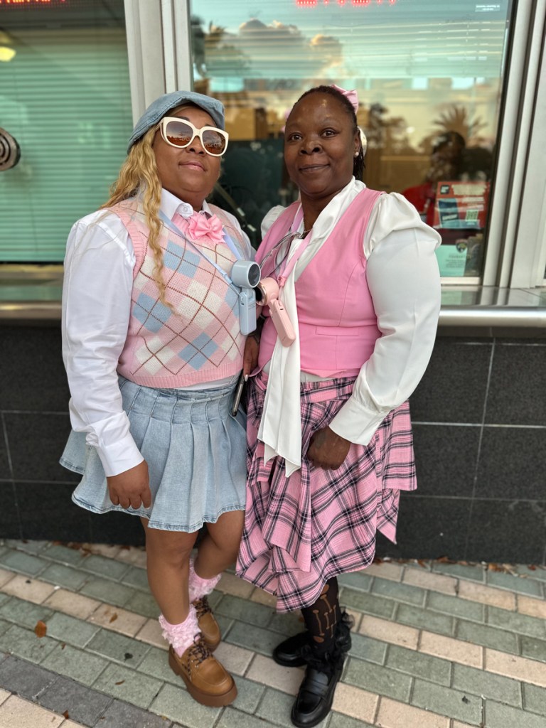 Photo of two women dressed in pink and light blue 