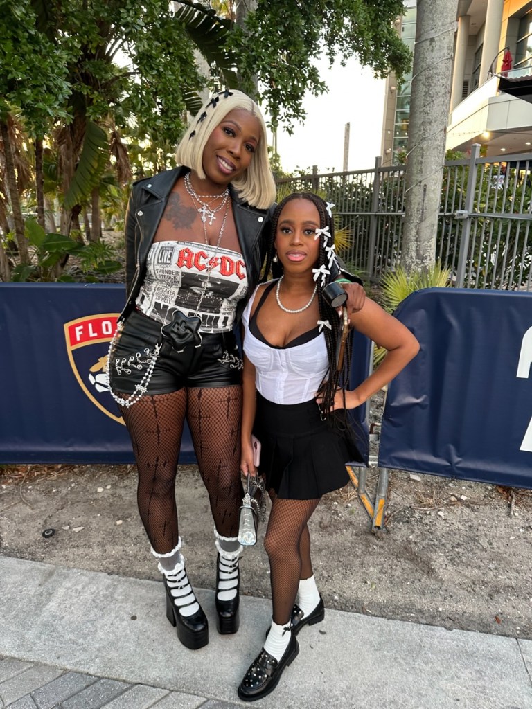 Photo of Fans at the Cardi B wearing black and white outfits.