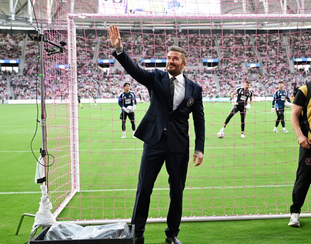photo of David Beckham waving to fans from the soccer field at Inter Miami's Nu Stadium