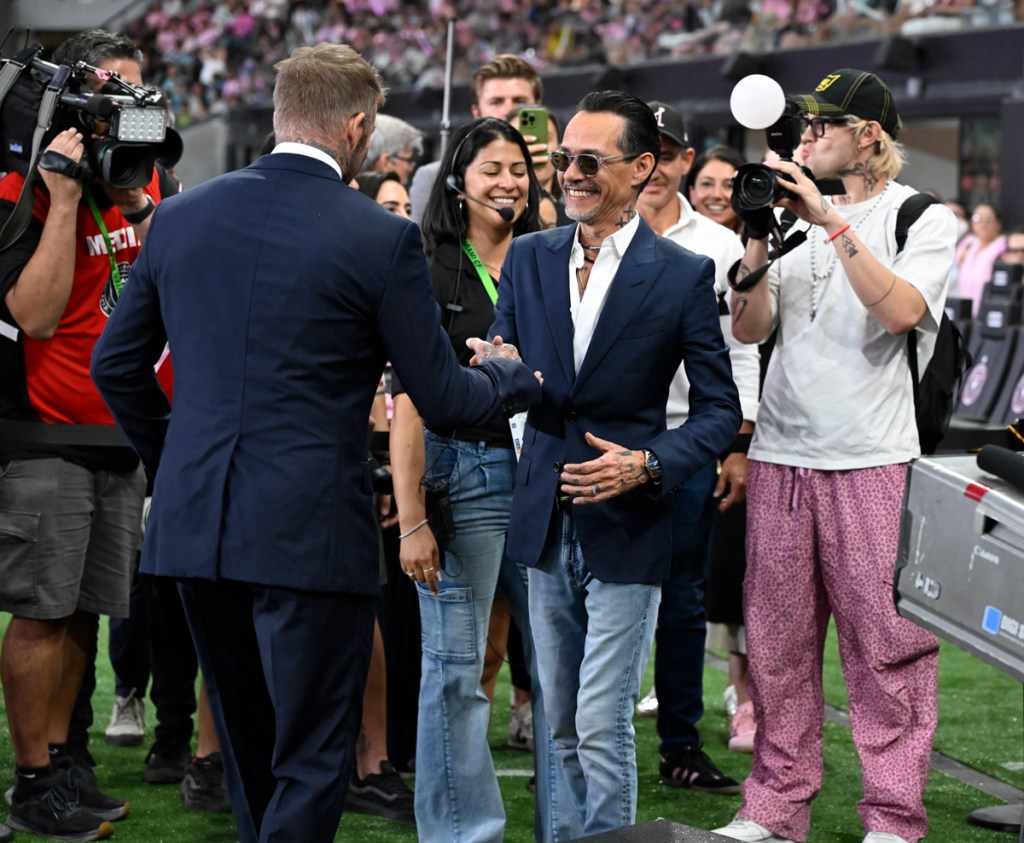 photo of photographers surrounding Marc Anthony and David Beckham as they shake hands at the opening of Nu Stadium in Miami