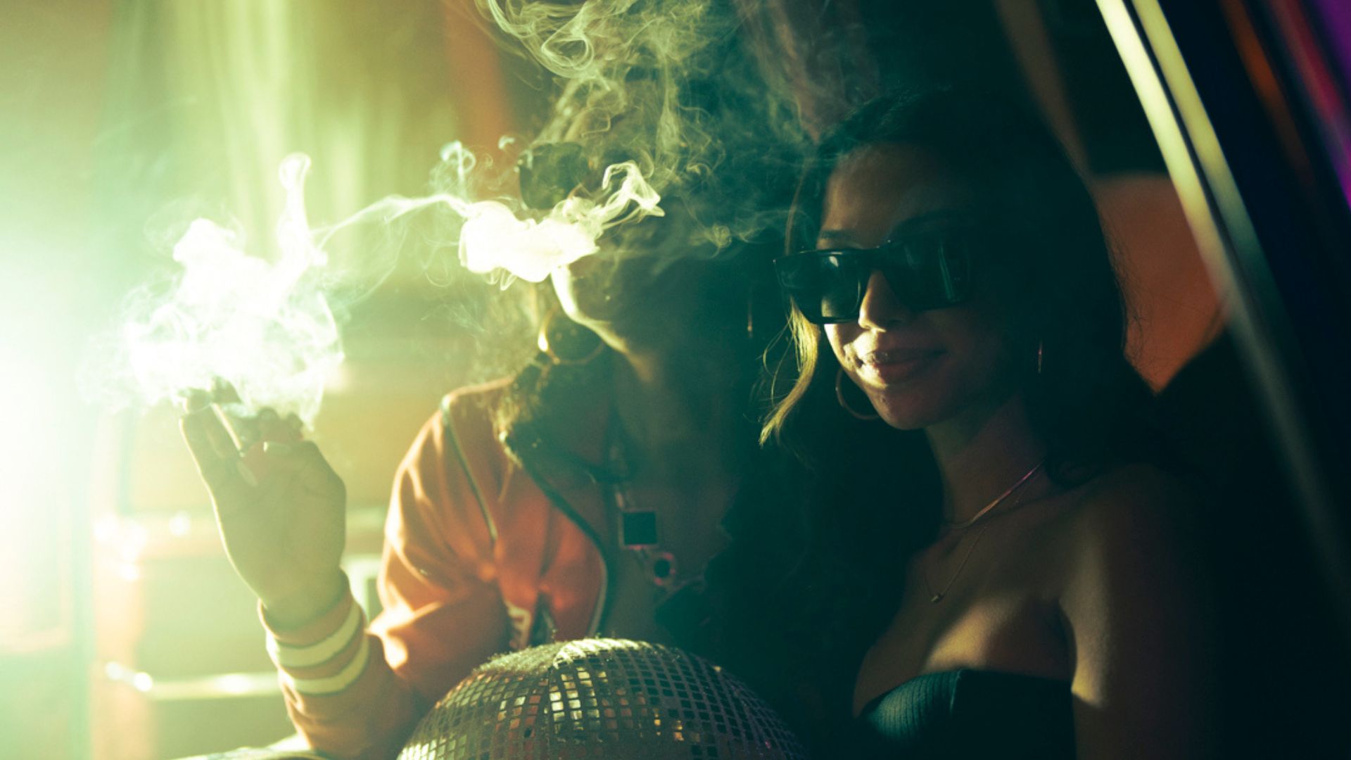 Photo of two young women surrounded by smoke.