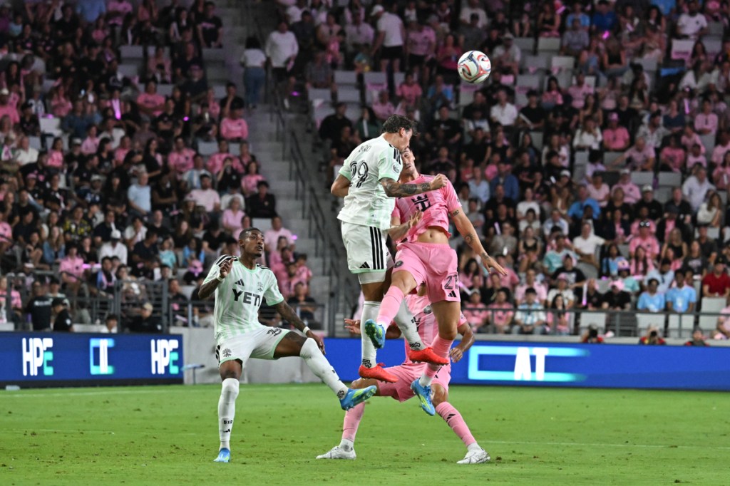 photo of Inter Miami FC and Austin FC soccer players leaping off the ground at Nu Stadium's inaugural match