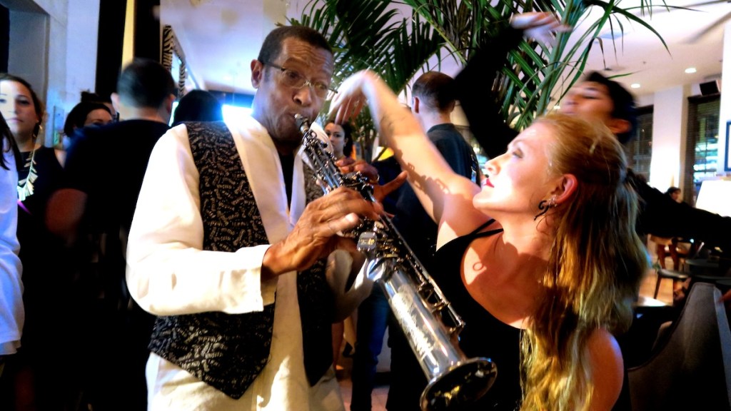 Photo of a woman dancing next to a man playing the clarinet