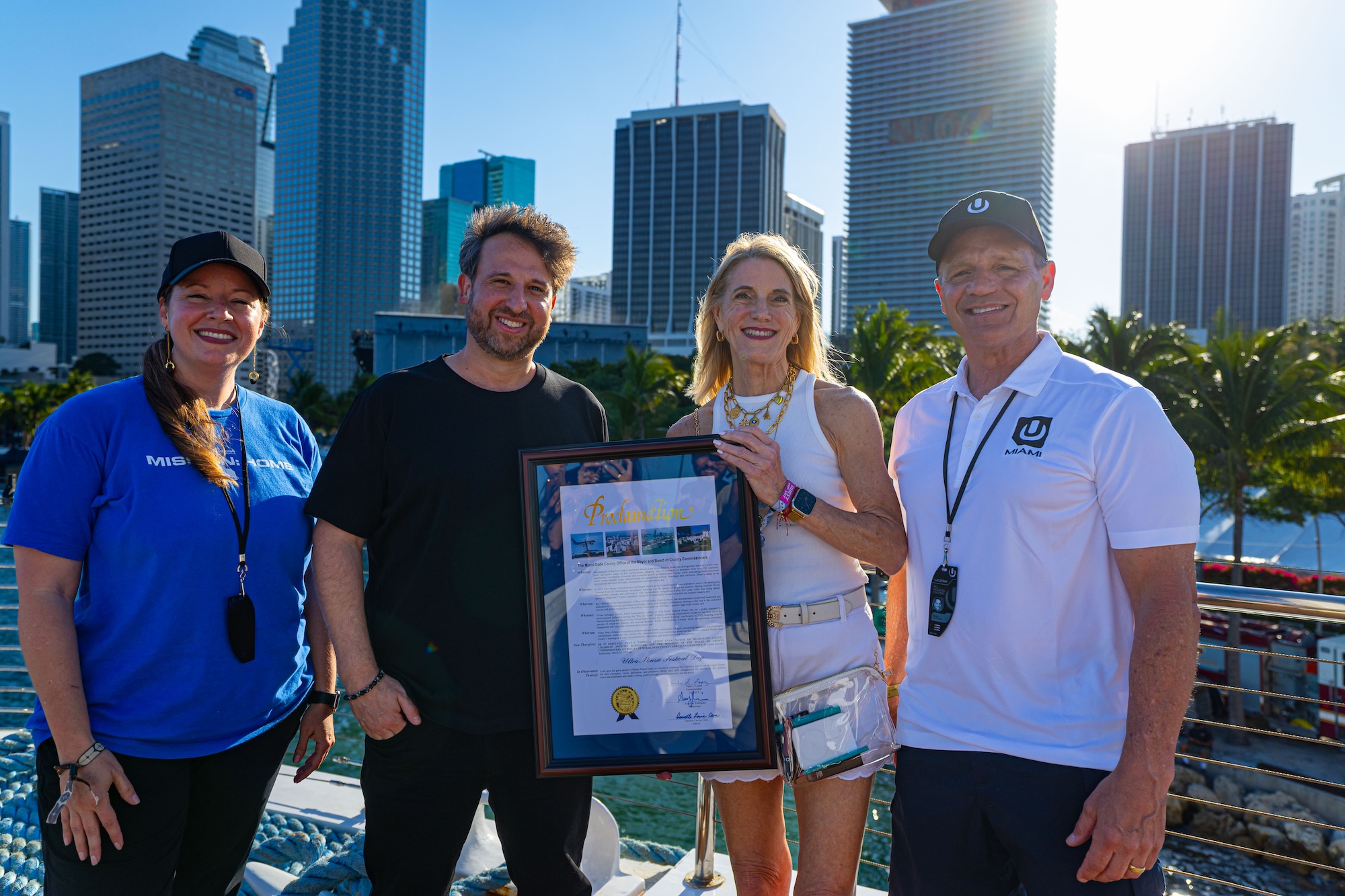 Photo of four people in Miami holding a proclamation that reads that Miami-Dade Declares March 28 Ultra Music Festival Day