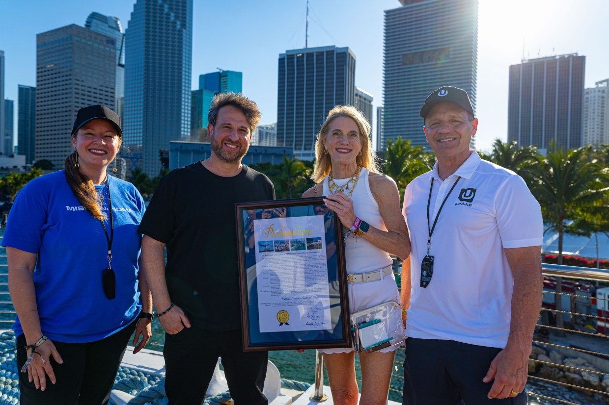 Photo of four people in Miami holding a proclamation that reads that Miami-Dade Declares March 28 Ultra Music Festival Day