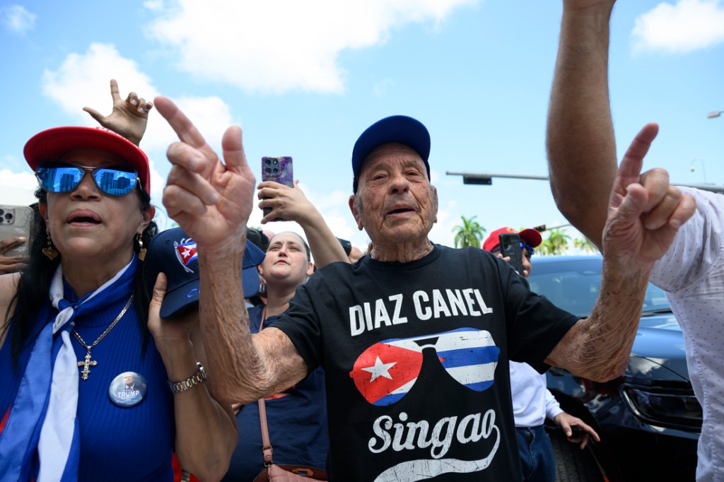 photo of protesters celebrating in the street in Miami after the indictment of Raul Castro