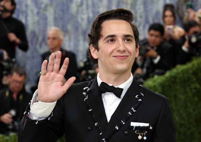 photo of Marcello Hernandez waving to photographers on the Met Gala red carpet