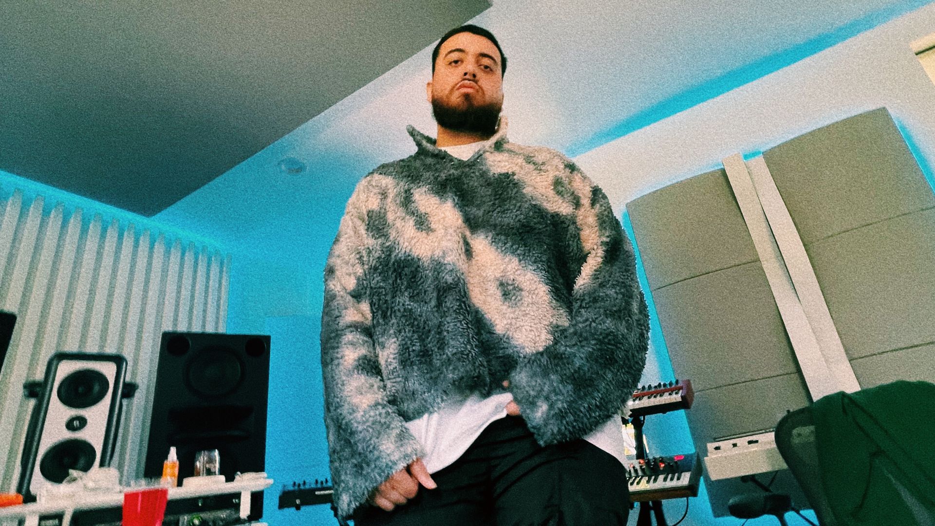 Photo of a man standing in a small studio.