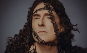 photo of “Weird Al” Yankovic with ribbon depicting music notes wrapped around his face