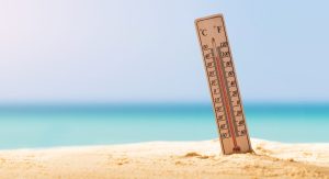 close-up photo of a thermometer on sand showing high temperature