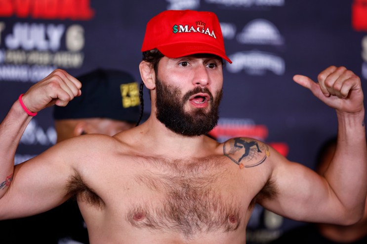 photo of MMA fighter Jorge Masvidal wearing a red MAGA hat and flexing at weigh-in